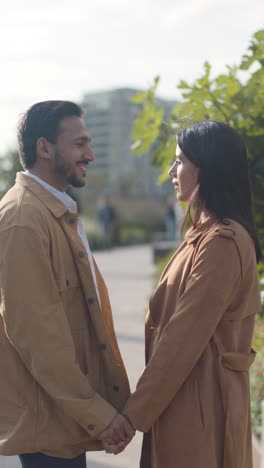 Vertical-Video-Of-Loving-Muslim-Couple-On-Date-Walking-Through-City-Park-Holding-Hands-Together-1